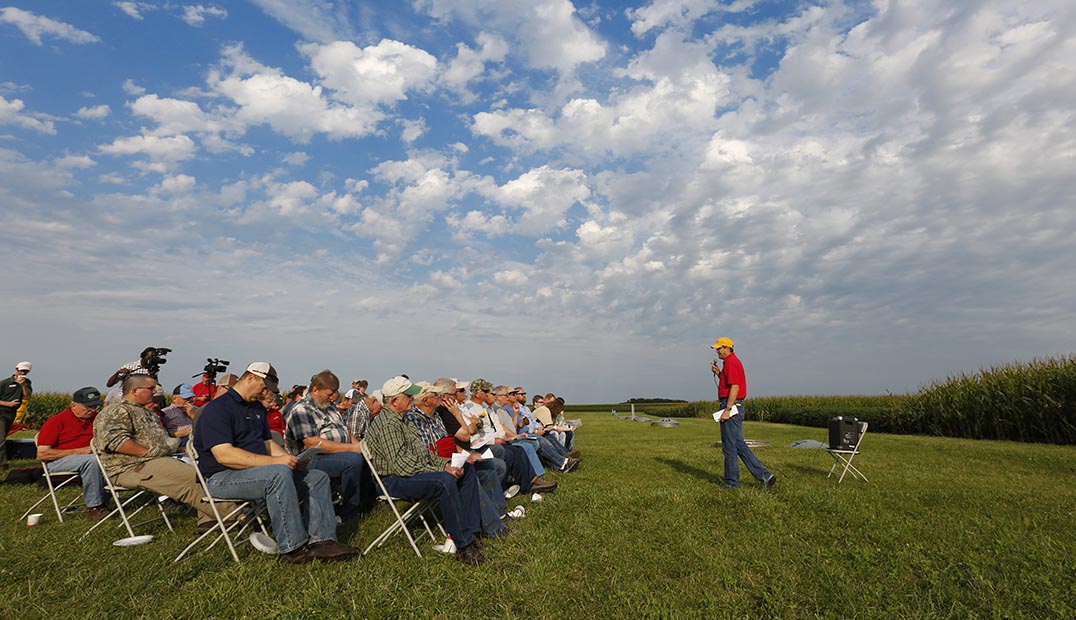 An Extension specialist addresses a crowd at a Field Day event.