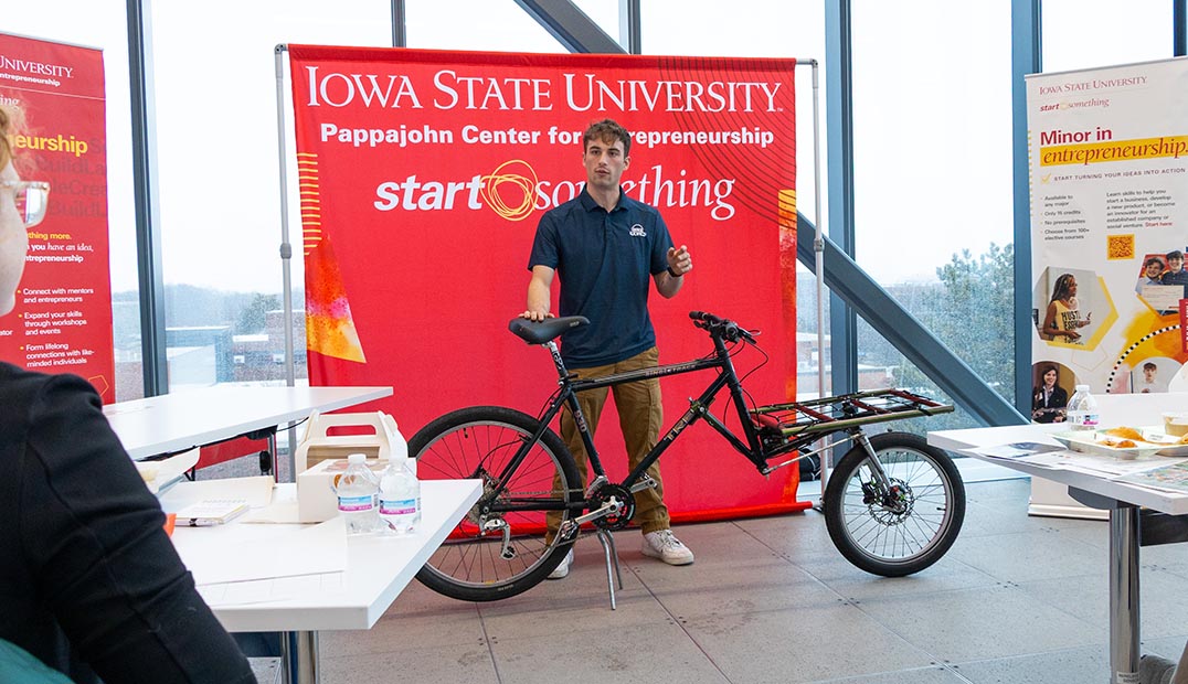 A student displays a bike as part of his Pitch Off presentation.